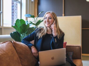 woman in blue long sleeve shirt using silver macbook